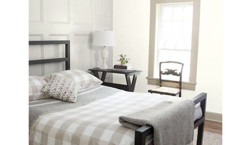 A white bedroom with panelled walls painted in Classic Gray OC-23.
