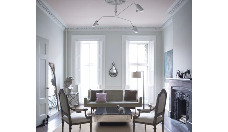A living room in a blue gray paint is accented by a pale pink ceiling. A living room in a blue gray paint is accented by a pale pink ceiling.