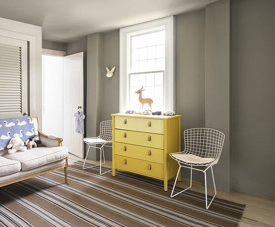 Sitting area: gray walls, greige sofa, metal basket chairs, ombré yellow dresser, deer statue & bunn Sitting area: gray walls, greige sofa, metal basket chairs, ombré yellow dresser, deer statue & bunn
