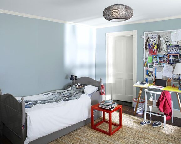 Teen bedr w/ blue walls, geometric desk, chair, end table, & astronaut bedspread. Teen bedr w/ blue walls, geometric desk, chair, end table, & astronaut bedspread.