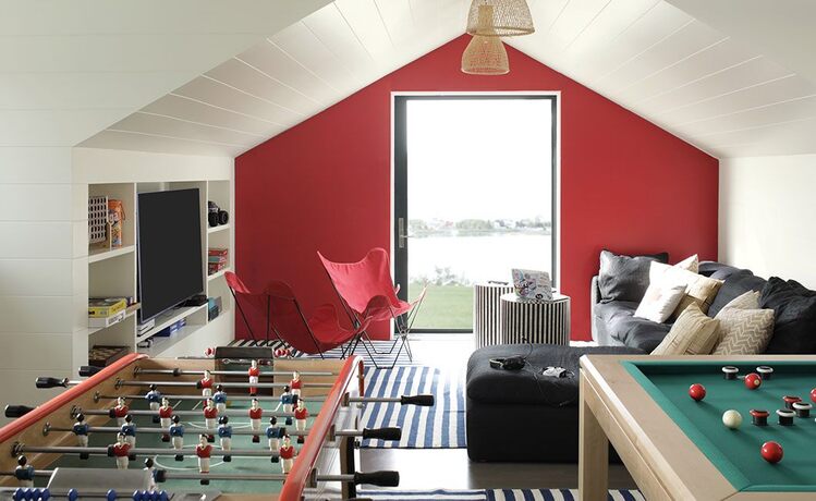 Game room w/ red accent wall, pool & foosball tables, leather sofas, chairs, big TV & striped tables Game room w/ red accent wall, pool & foosball tables, leather sofas, chairs, big TV & striped tables