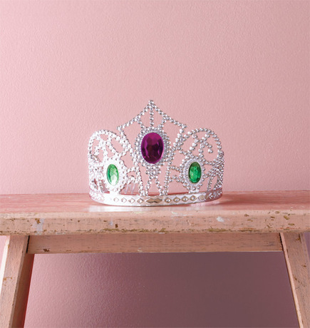 A pink-hued wall sets off a bejewelled tiara. A pink-hued wall sets off a bejewelled tiara.
