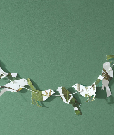 A light green-painted wall is backdrop for an origami banner. A light green-painted wall is backdrop for an origami banner.
