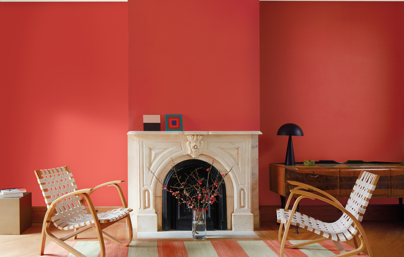 Living room with Raspberry Blush red-painted walls, white marble fireplace and relaxed seating. Living room with Raspberry Blush red-painted walls, white marble fireplace and relaxed seating.