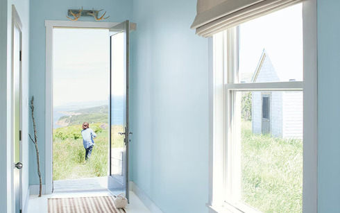 Hallway walls with light blue Breath of Fresh Air 806 color, white trim, and open door.