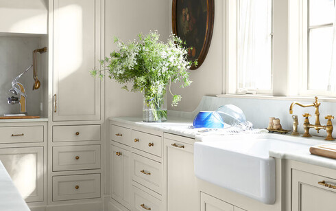 White-painted kitchen in color Gray Mist CC-80 with ample counter space and kitchen island.