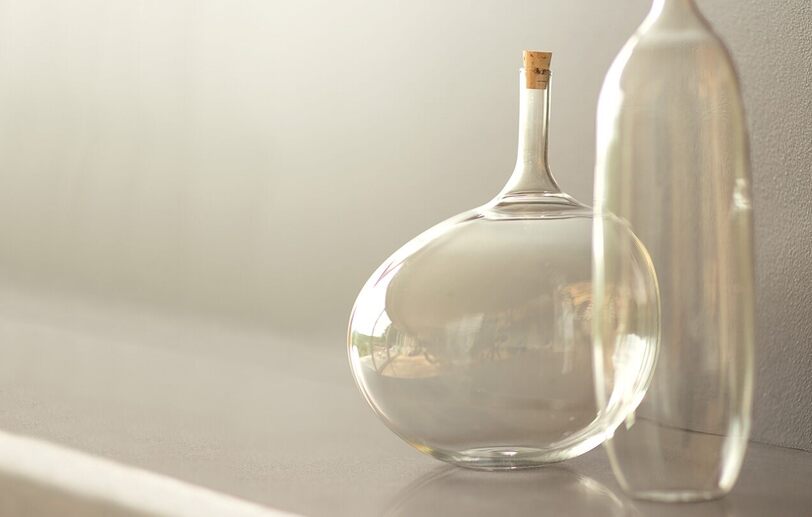 Glass vases set against a wall painted in light griege Barren Plain 2111-60. Glass vases set against a wall painted in light griege Barren Plain 2111-60.