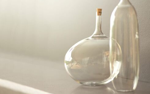 Glass vases set against a wall painted in light griege Barren Plain 2111-60.